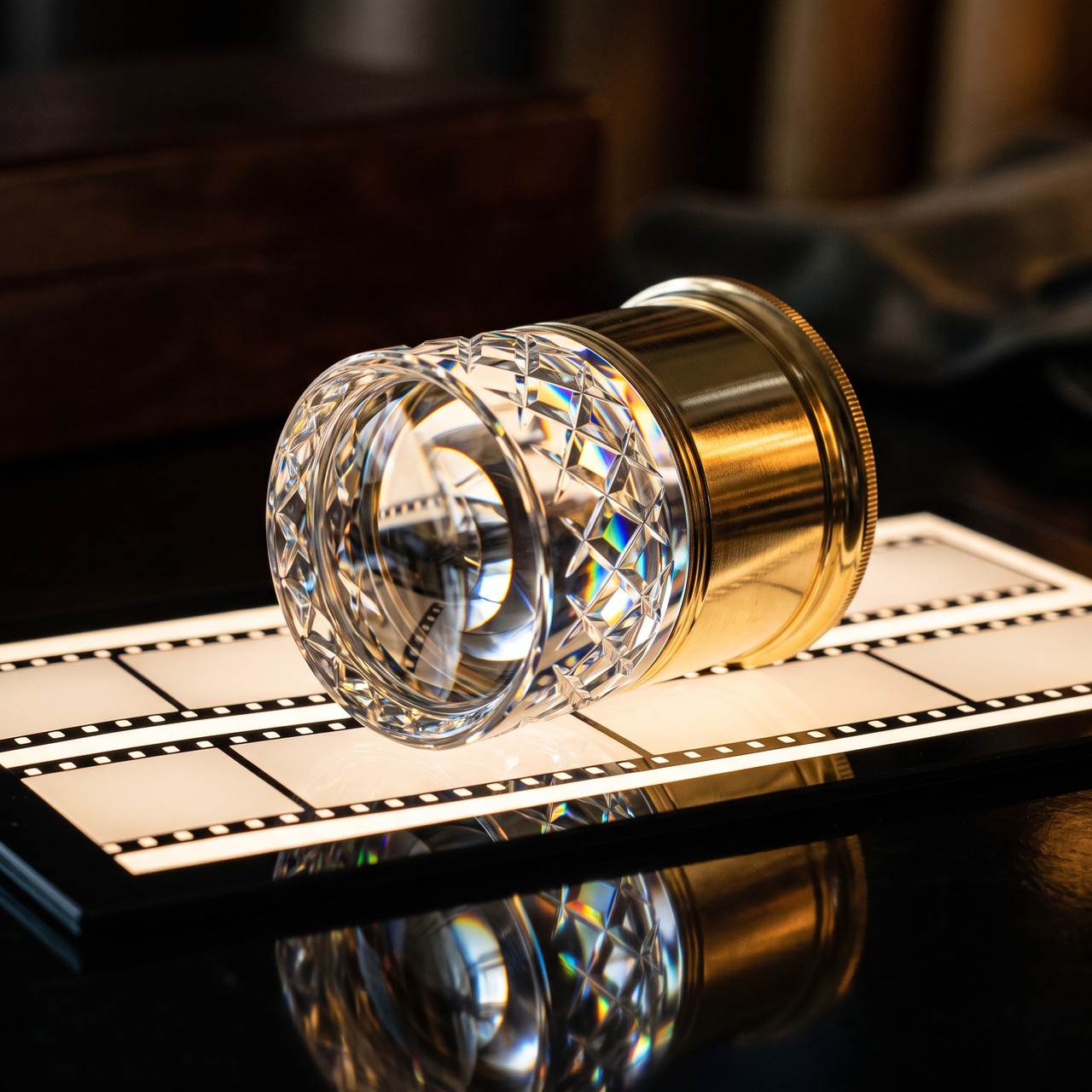 A crystal loupe resting on a lightbox