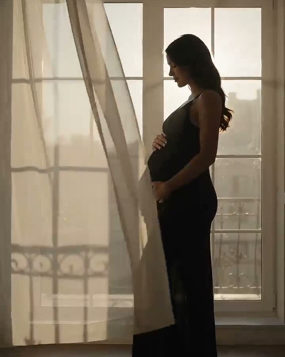 A softly backlit silhouette at a sunlit window
